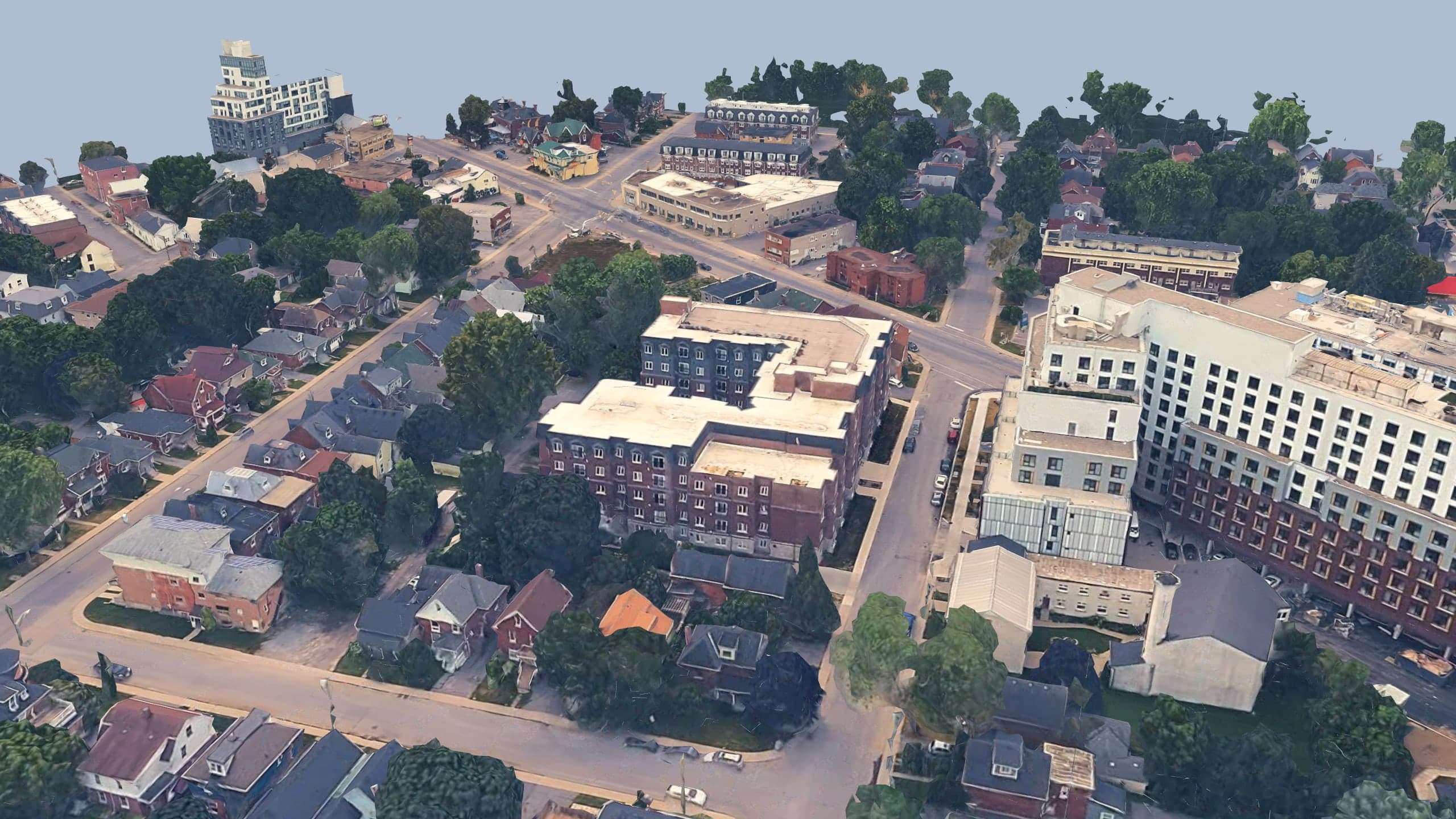 Aerial photograph of The Frontenac, its red brick courtyard block in the Williamsville street grid